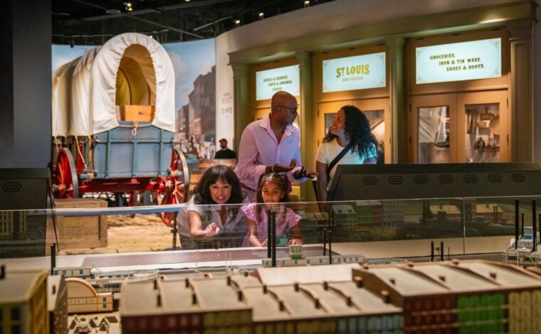 Family explores the museum under the Gateway Arch in the Riverfront Era Gallery
