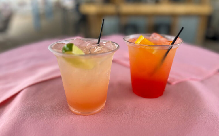 Two colorful tequila cocktails, the Mississippi River Sunrise and Sparkling Paloma, on a table.
