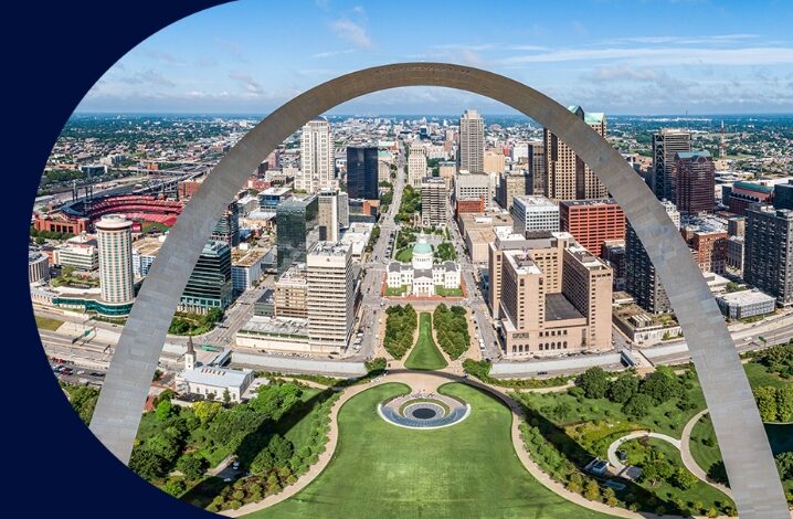 Drone view of the arch facing the Old Courthouse and the grounds in between. This shot features part of the St. Louis skyline, park grounds and connecting streets.